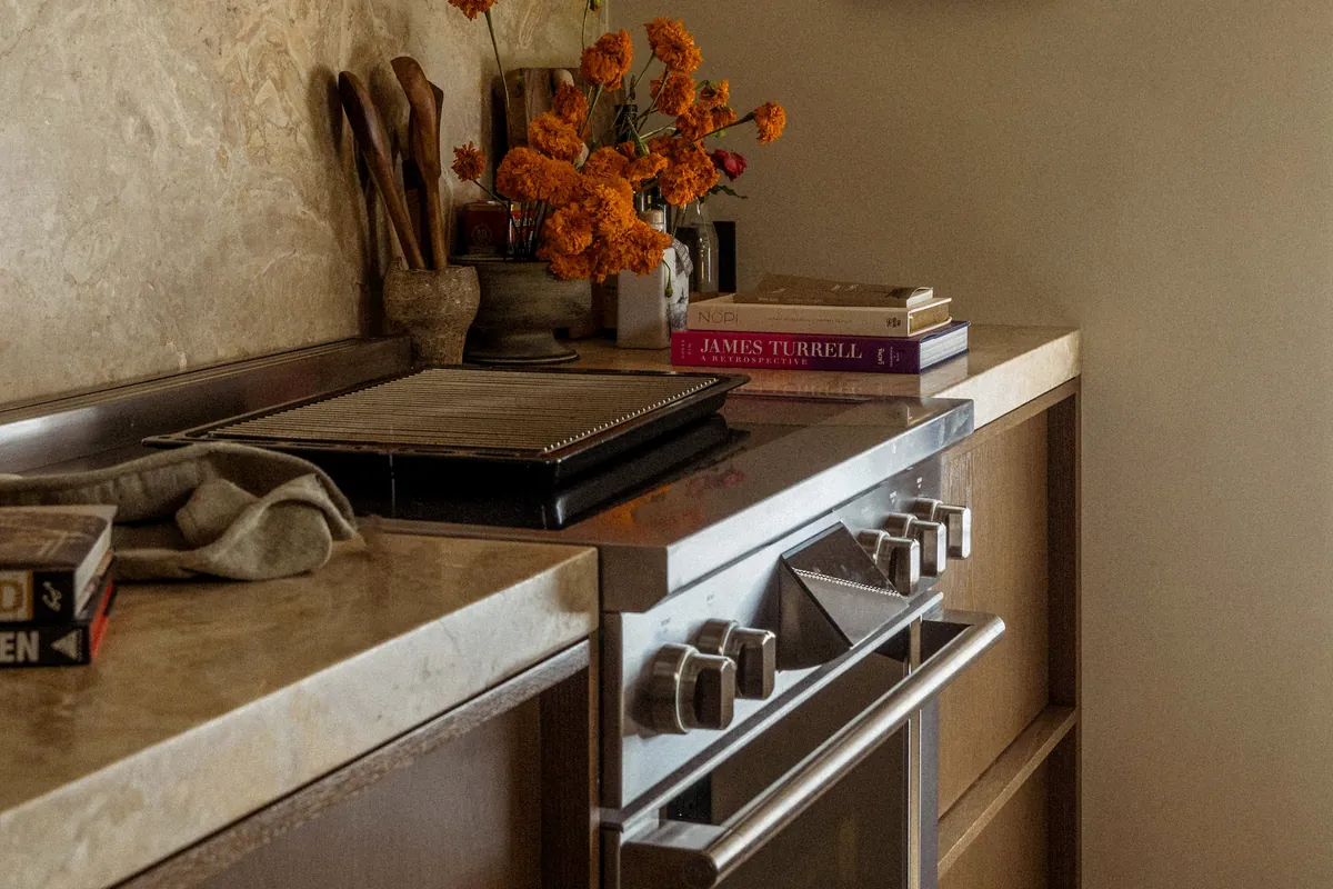 Kitchen remodel by Apex Builders: stainless range, honed stone counters and a plaster backsplash
